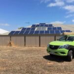 ute in front of roof with solar panels